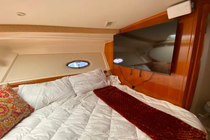 Slide: The Image of Cozy bedroom in 2003 Carver 350 Mariner yacht with TV and porthole window. - 18