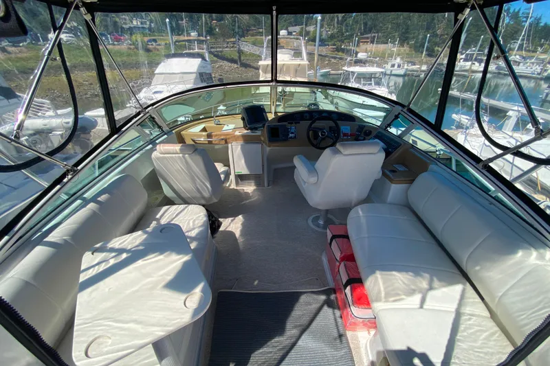 Slide: The Image of Interior view of a 2003 Carver 350 Mariner yacht with spacious seating and helm. - 26