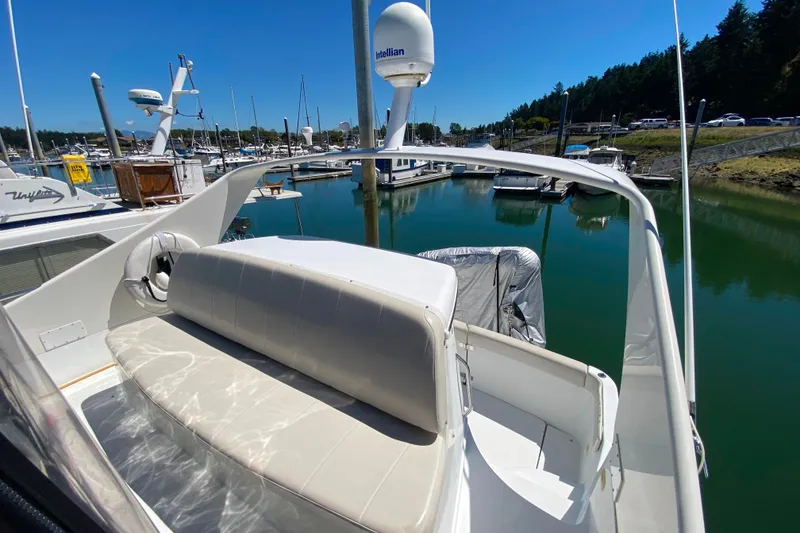 Slide: The Image of 2003 Carver 350 Mariner yacht docked in a marina, featuring a spacious seating area. - 23