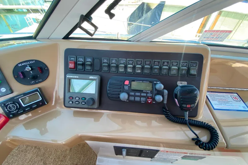 Slide: The Image of Control panel of a 2003 Carver 350 Mariner boat with navigation and communication equipment. - 32