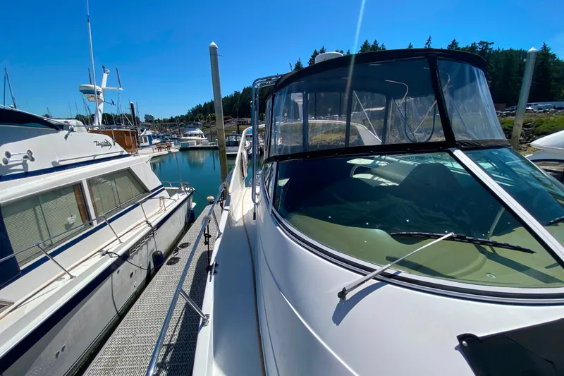 Slide: The Image of 2003 Carver 350 Mariner docked at a marina under clear blue skies. - 50