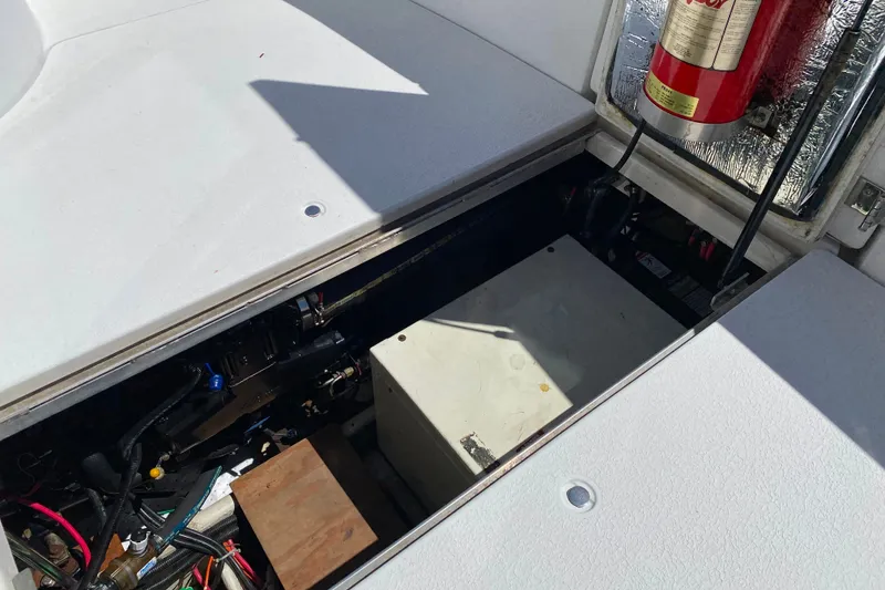 Slide: The Image of Engine compartment of a 2003 Carver 350 Mariner boat, featuring wiring and a fire extinguisher. - 41