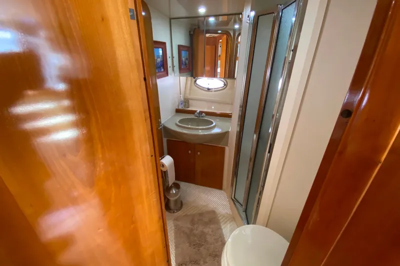 Slide: The Image of Bathroom interior of 2003 Carver 350 Mariner yacht, featuring sink, toilet, and shower. - 20
