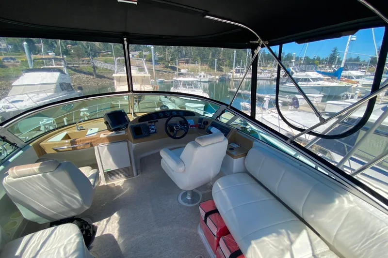 Slide: The Image of Interior view of 2003 Carver 350 Mariner yacht cockpit with marina background. - 27