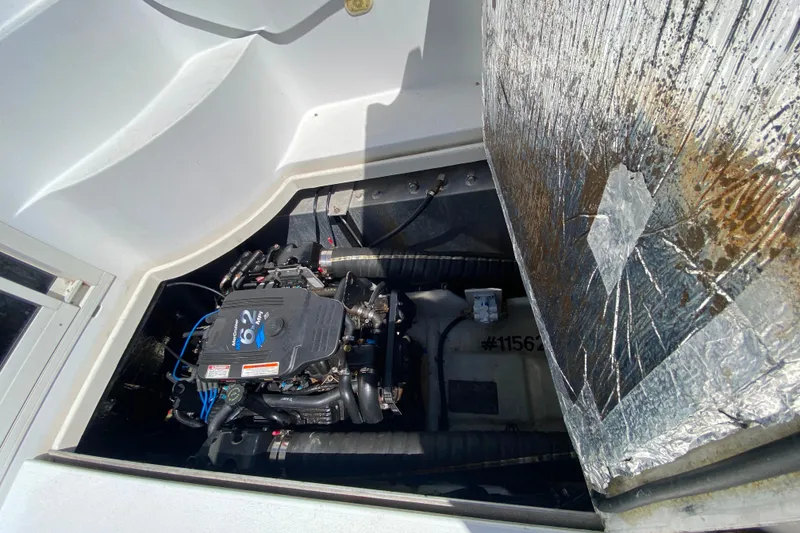 Slide: The Image of Engine compartment of a 2003 Carver 350 Mariner boat, showcasing the engine details. - 36