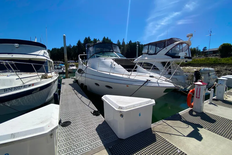 Slide: The Image of 2003 Carver 350 Mariner yacht docked at marina under clear blue sky. - 53