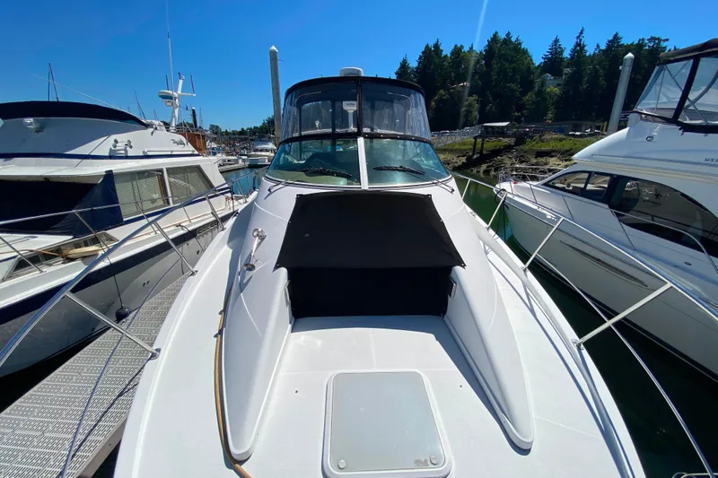 Slide: The Image of 2003 Carver 350 Mariner yacht docked at marina, surrounded by other boats. - 48
