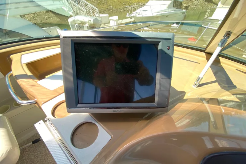 Slide: The Image of Garmin navigation system on 2003 Carver 350 Mariner yacht dashboard, with marina view. - 29