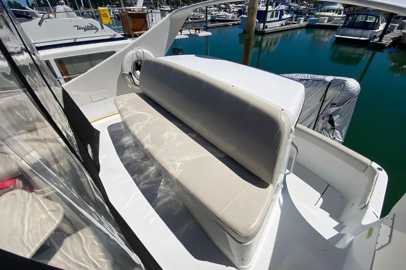 Slide: The Image of 2003 Carver 350 Mariner boat with white seating at a marina. - 24