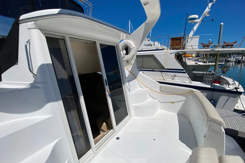 Slide: The Image of 2003 Carver 350 Mariner yacht with open sliding door, docked at marina. - 21