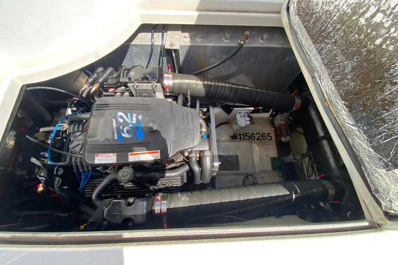 Slide: The Image of Engine compartment of a 2003 Carver 350 Mariner boat, featuring a MerCruiser 6.2 MPI engine. - 37