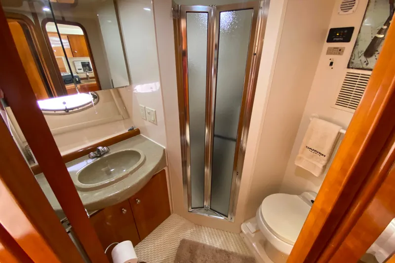 Slide: The Image of Bathroom interior of 2003 Carver 350 Mariner yacht, featuring sink, shower, and toilet. - 19