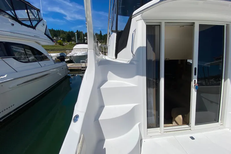 Slide: The Image of 2003 Carver 350 Mariner yacht with sliding door and exterior stairs in marina. - 22
