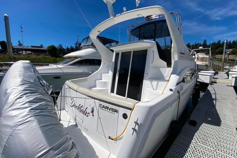 Slide: The Image of 2003 Carver 350 Mariner yacht docked under clear blue sky. - 52