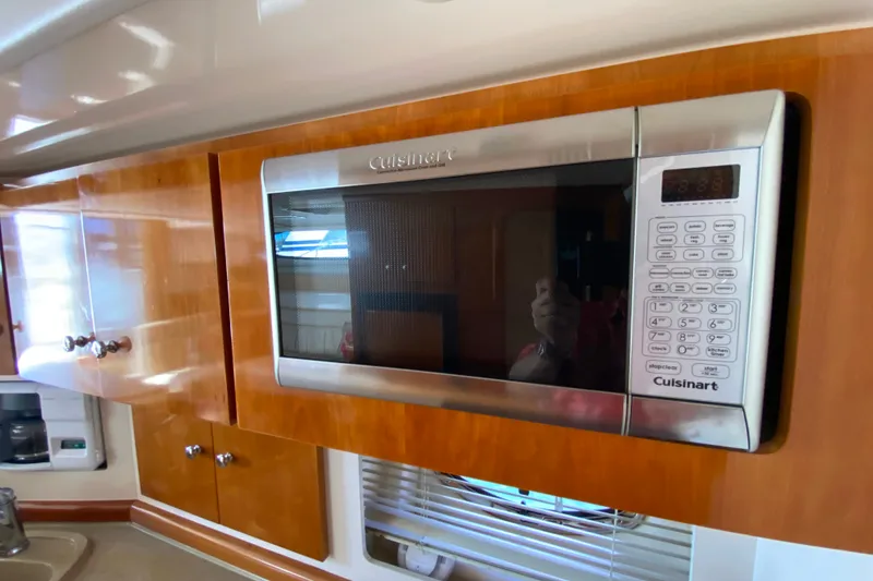 Slide: The Image of Cuisinart microwave in 2003 Carver 350 Mariner yacht kitchen with wooden cabinetry. - 13