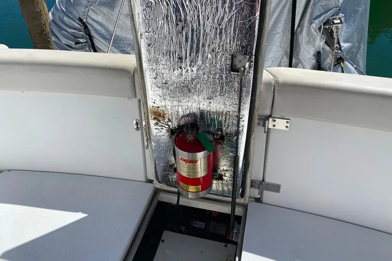 Slide: The Image of 2003 Carver 350 Mariner boat interior with fire extinguisher and reflective insulation. - 44