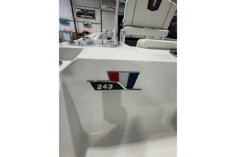 Slide: The Image of 2026 Wellcraft 243 Fisherman boat interior with logo and seating detail. - 6
