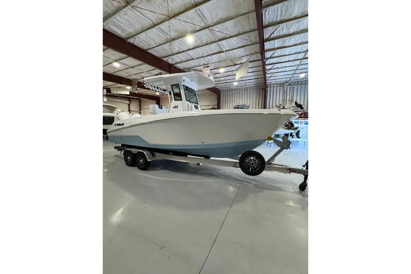 Slide: The Image of 2026 Wellcraft 243 Fisherman boat on trailer in indoor showroom. - 3