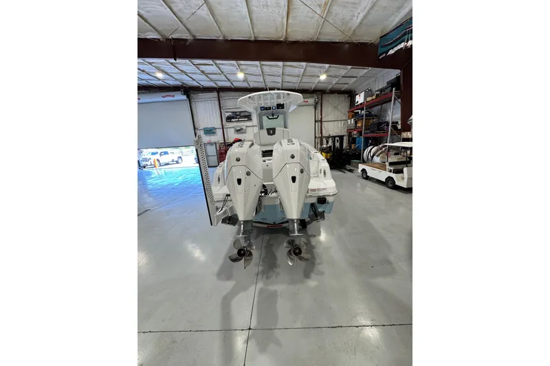 Slide: The Image of 2026 Wellcraft 243 Fisherman boat in a spacious indoor storage facility. - 5
