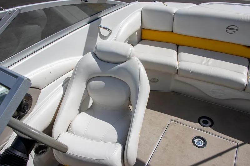 Slide: The Image of The image shows the interior of a 2008 Crownline 210 LS boat with white upholstery. - 12