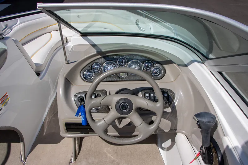 Slide: The Image of The image shows the cockpit of a 2008 Crownline 210 LS boat with a modern dashboard. - 9