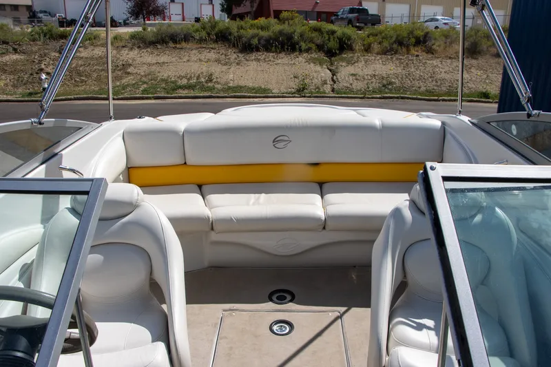 Slide: The Image of The image shows the cockpit of a 2008 Crownline 210 LS boat with white seating. - 11