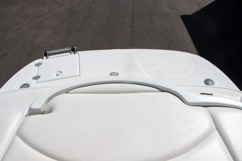 Slide: The Image of The image shows the stern of a 2008 Crownline 210 LS boat with a white sun pad. - 13
