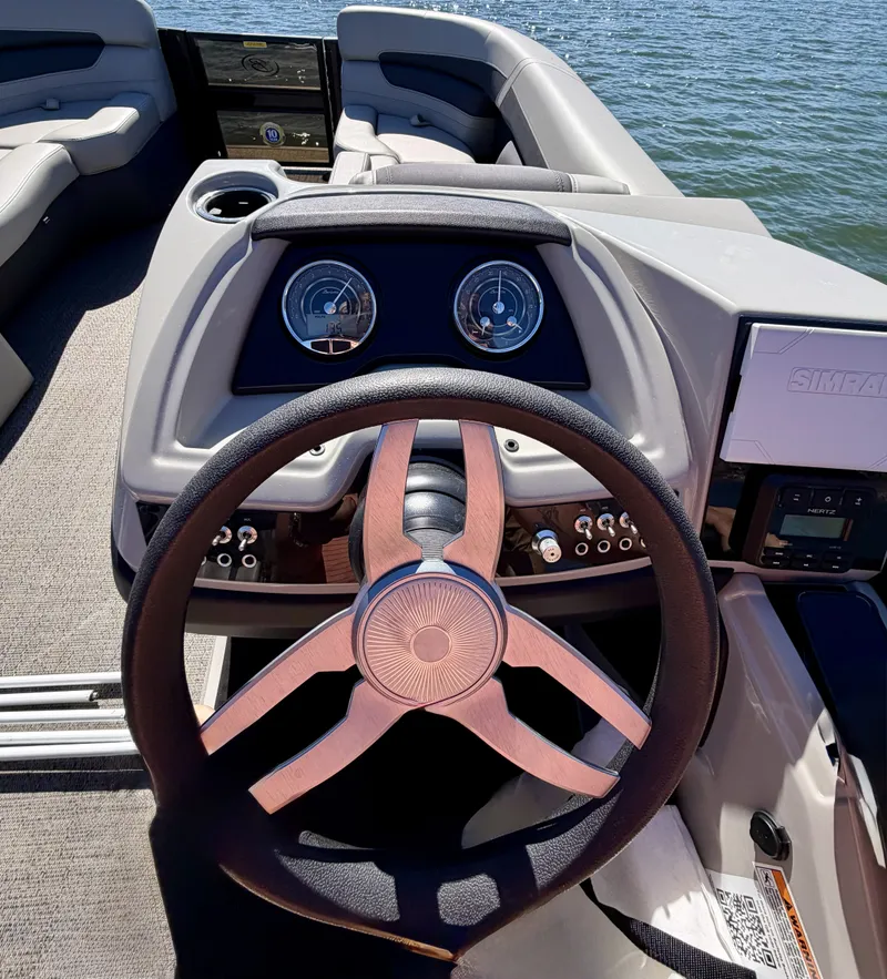 Slide: The Image of The image shows the helm of a 2024 Barletta Cabrio 24 UE with modern instruments. - 17