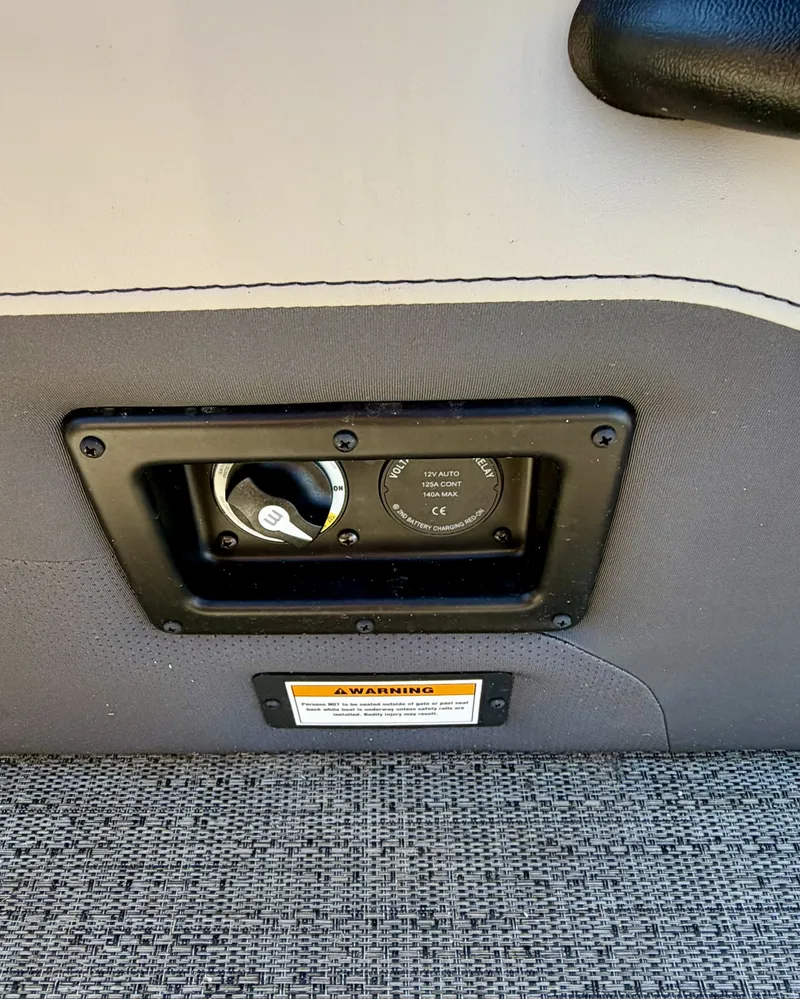 Slide: The Image of Close-up of a control panel on a Barletta Cabrio 24 UE boat, surrounded by upholstered material. - 10