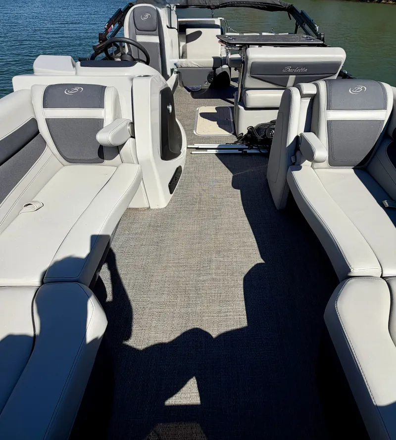 Slide: The Image of The image shows the interior of a 2024 Barletta Cabrio 24 UE with gray upholstered seating. - 13