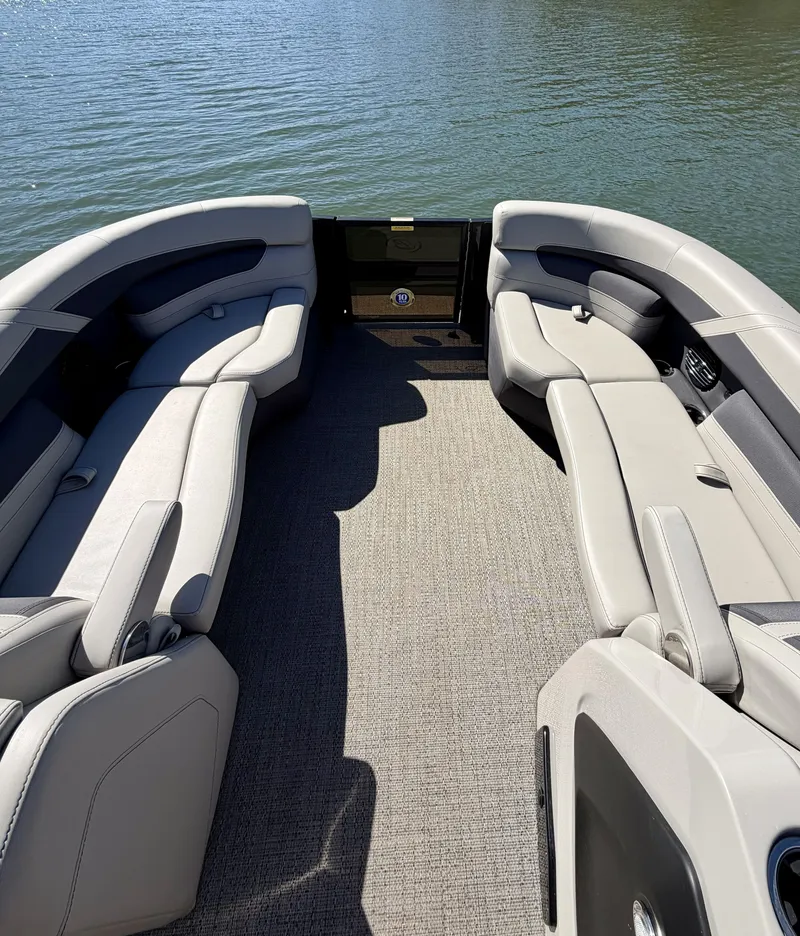 Slide: The Image of The image shows the spacious deck of a 2024 Barletta Cabrio 24 UE with gray upholstered seating. - 14