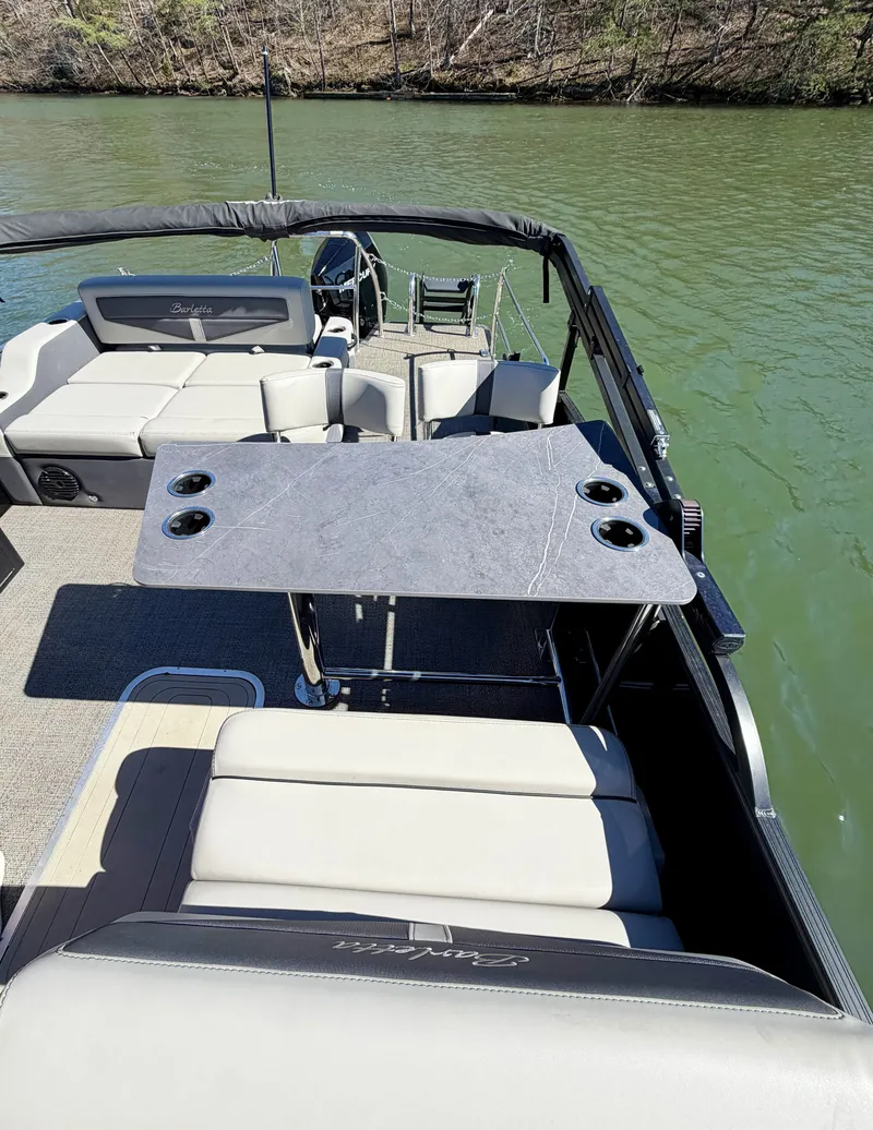 Slide: The Image of The image shows the deck of a 2024 Barletta Cabrio 24 UE with a table and seating. - 6