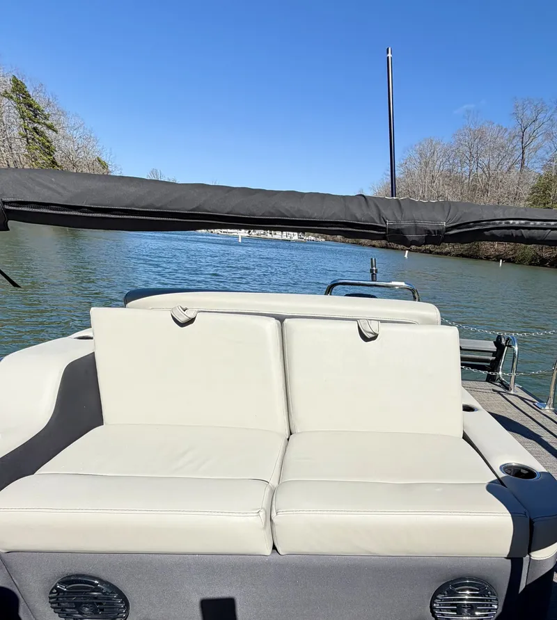 Slide: The Image of A 2024 Barletta Cabrio 24 UE with beige seating area, on a calm river. - 12