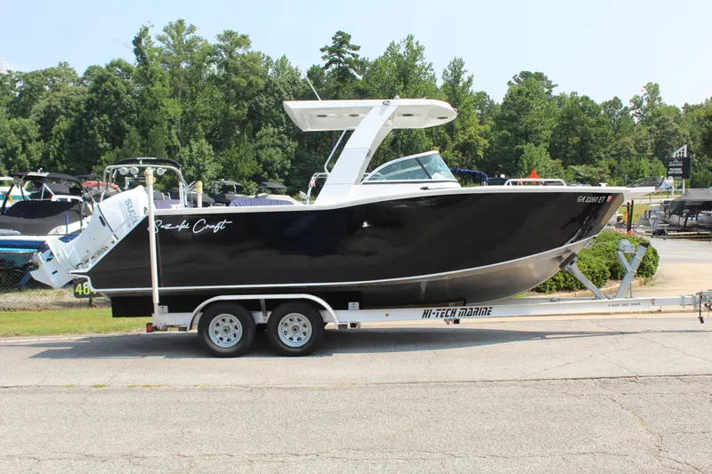Slide: The Image of Alaska Sea King Pro Fisher 23, 2024, on a trailer, with black hull and white roof. - 6