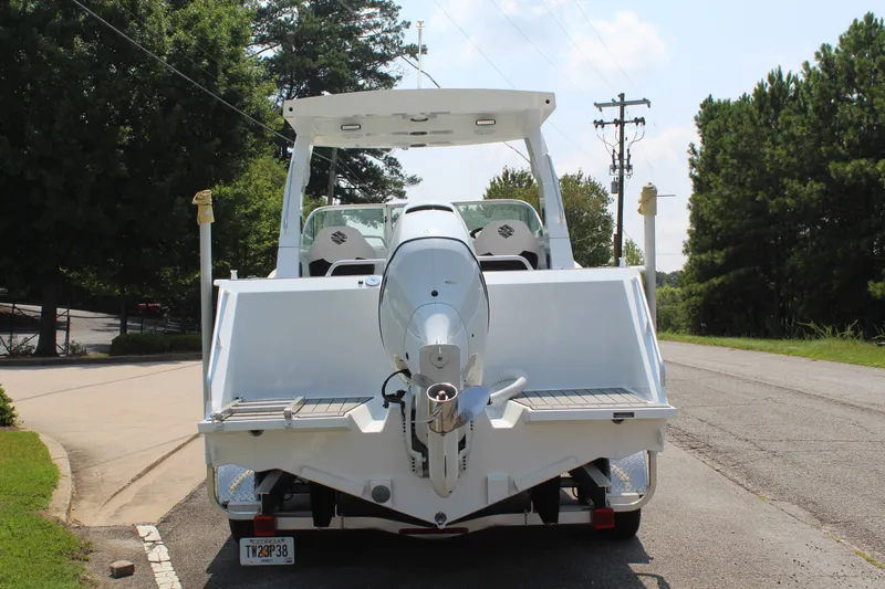 Slide: The Image of The image shows a white boat parked on a road. It features a large outboard motor. - 5