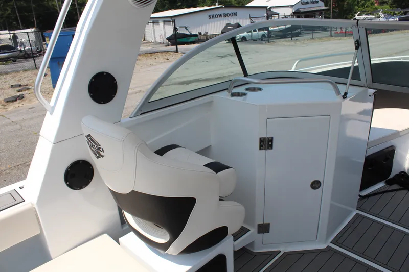 Slide: The Image of The image shows the cockpit of a 2024 Alaska Sea King Pro Fisher 23 with a white seat and helm. - 11