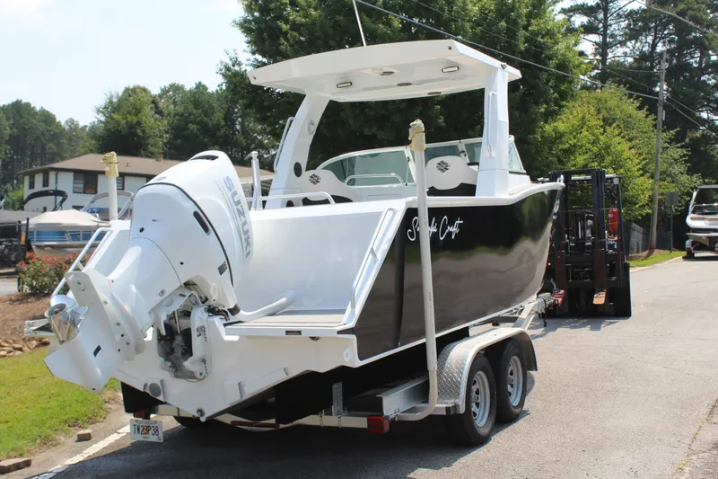 Slide: The Image of A modern black and white 2024 Alaska Sea King Pro Fisher 23 on a trailer. - 8