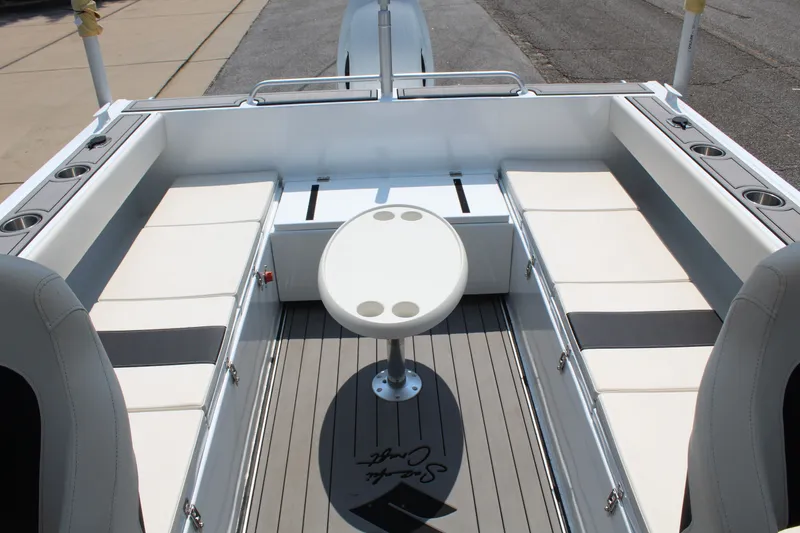 Slide: The Image of The image shows the cockpit of a 2024 Alaska Sea King Pro Fisher 23 with white bench seating. - 12