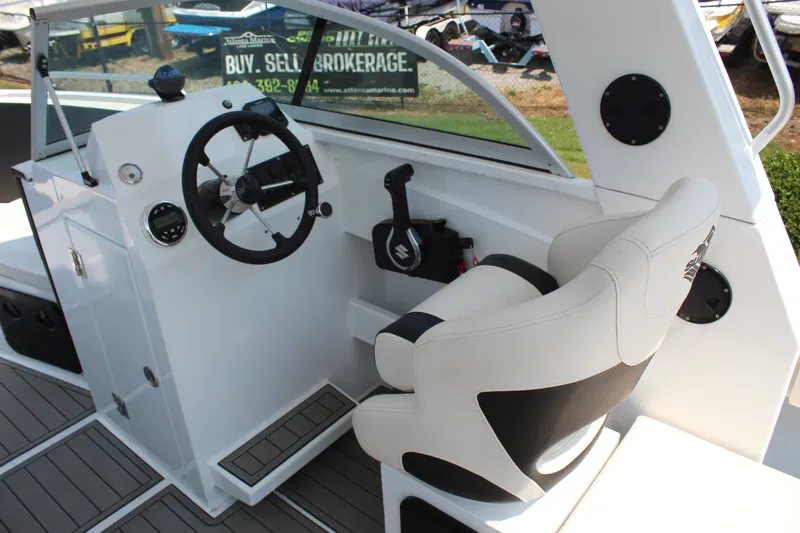 Slide: The Image of The image shows the cockpit of a 2024 Alaska Sea King Pro Fisher 23 with a modern helm. - 10