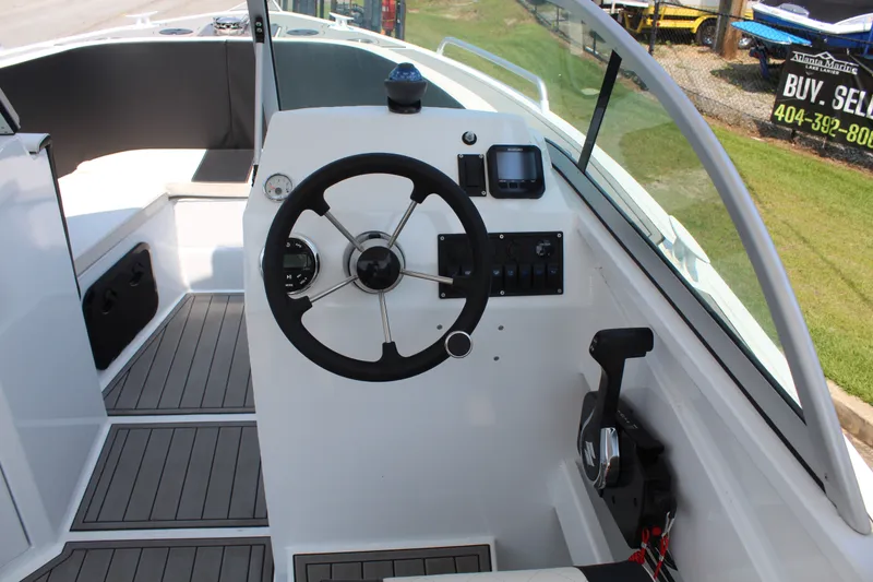 Slide: The Image of The cockpit of the 2024 Alaska Sea King Pro Fisher 23 features a modern steering wheel and instruments. - 9