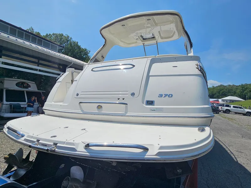 Slide: The Image of The image shows the stern of a 2011 Chaparral 370 Signature. It features a large swim platform. - 2
