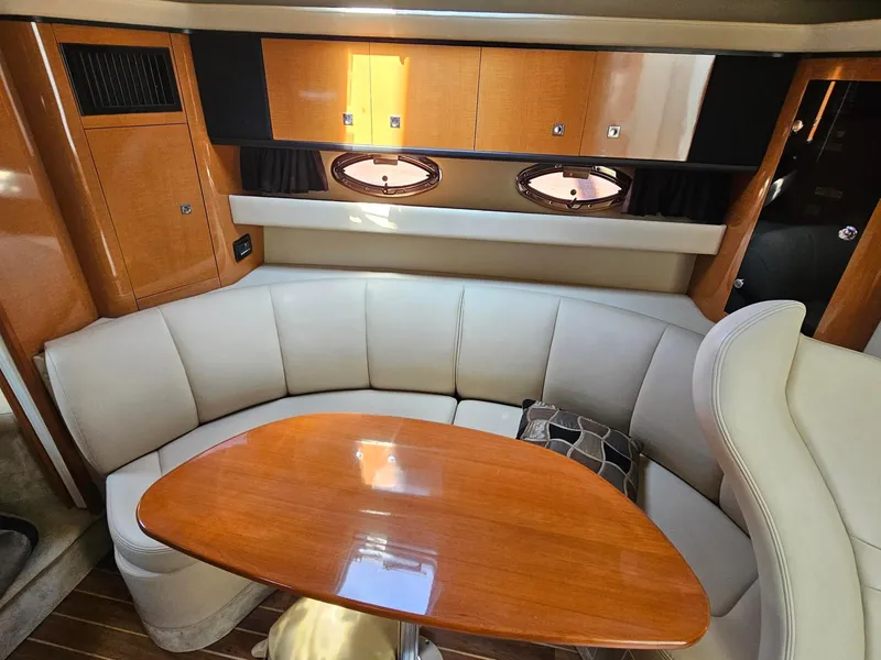 Slide: The Image of Interior of a 2011 Chaparral 370 Signature with an elegant seating area and wooden table. - 6