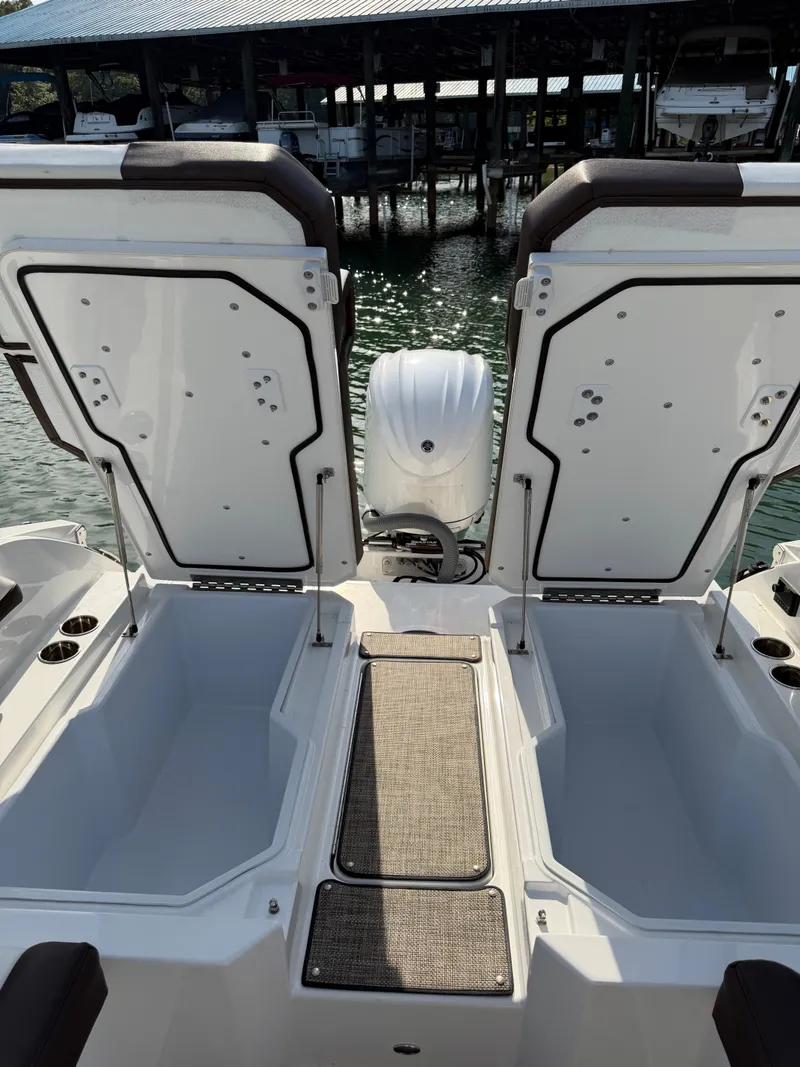 Slide: The Image of The image shows the stern of a 2022 Cobalt R6 Outboard boat with open storage compartments. - 9