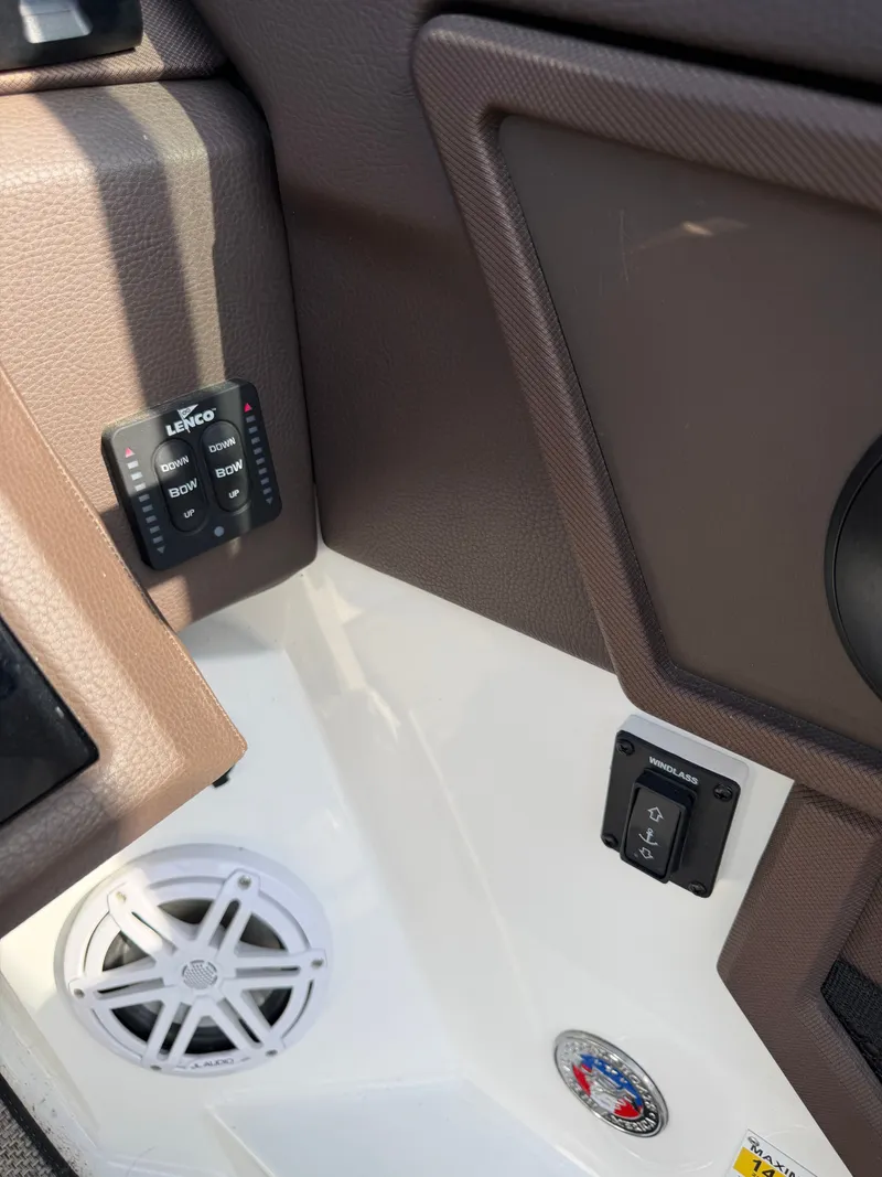 Slide: The Image of Close-up of the helm area in a 2022 Cobalt R6 Outboard, featuring controls and a speaker. - 7