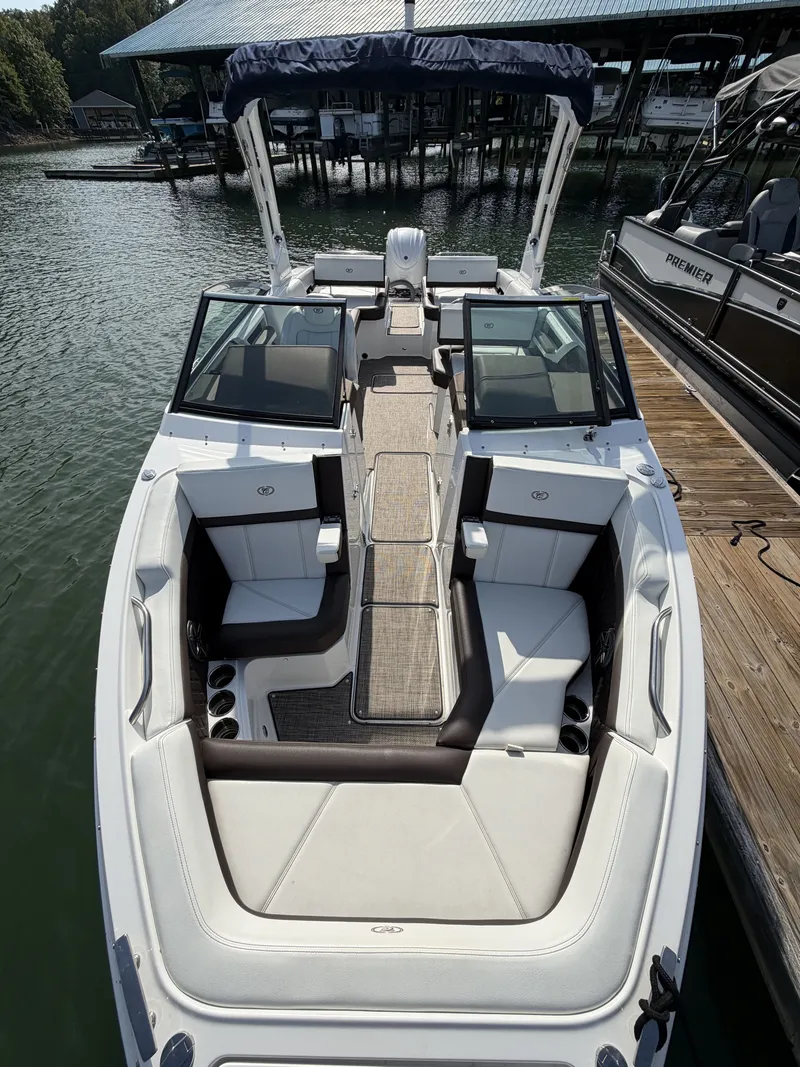 Slide: The Image of The image shows a 2022 Cobalt R6 Outboard boat with sleek white seating and an open deck. - 2