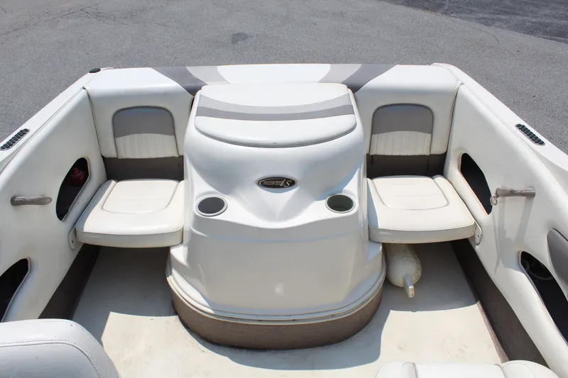 Slide: The Image of The image shows the interior of a 2012 Stingray 185 LS boat with white seating and cup holders. - 12