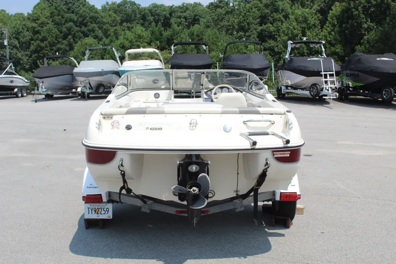 Slide: The Image of A white 2012 Stingray 185 LS boat on a trailer in a parking lot. - 5