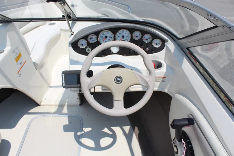 Slide: The Image of The image shows the cockpit of a 2012 Stingray 185 LS with a white steering wheel and dashboard. - 9