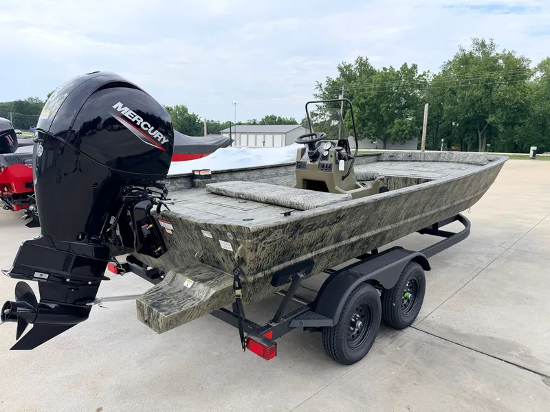 Slide: The Image of The image shows a 2027 Tracker Grizzly 2072 CC boat on a trailer. It features a Mercury outboard motor and camouflage paint. - 4