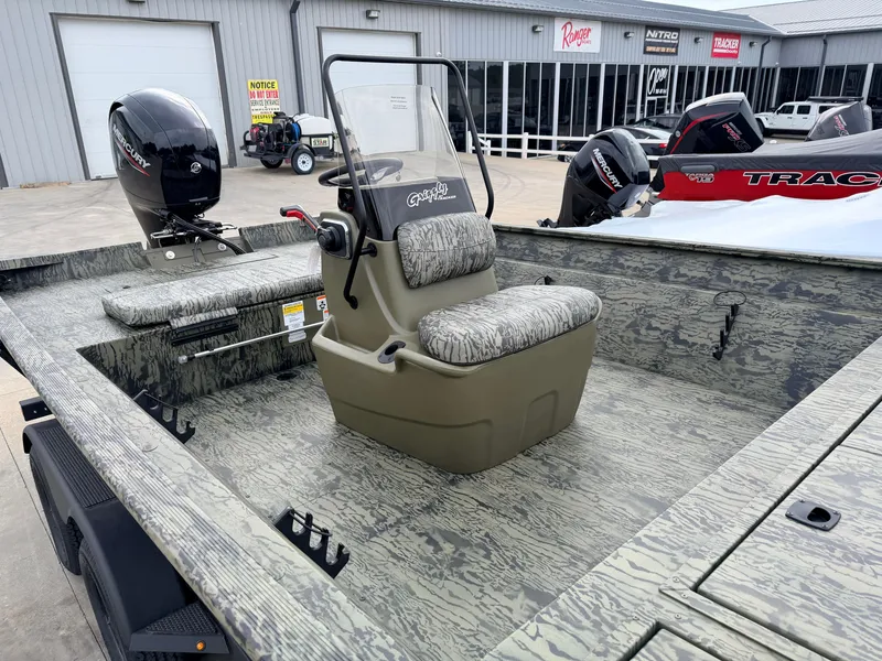 Slide: The Image of The image shows a Tracker Grizzly 2072 CC boat with a camo design and a center console. - 12